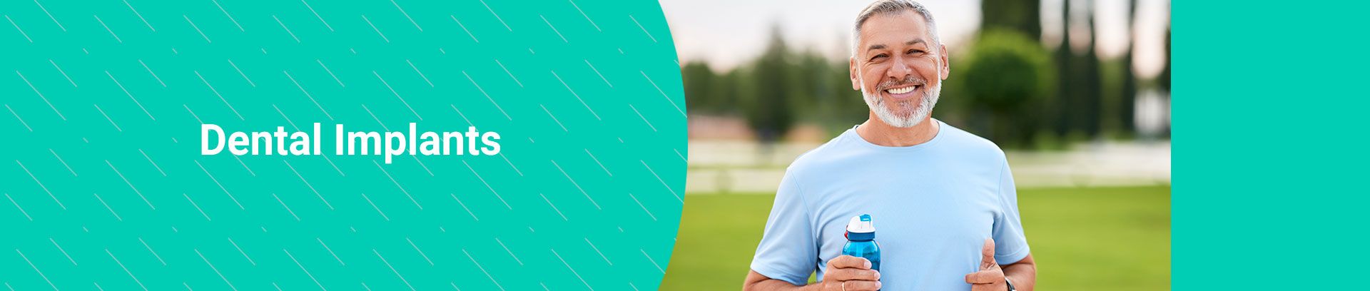 Smiling man holding a water bottle outdoors